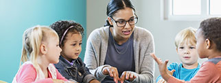 Teacher and children in a discussion round a table