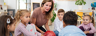 Adult with young children in class