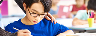 Pupil being helped by teacher in class