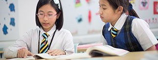 Students in class using textbooks 