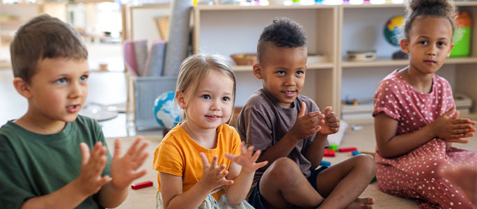 children in class clapping hands
