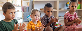 Children in class clapping hands