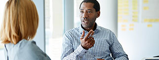 Two adults sat talking
