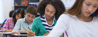 A row of learners working hard at their desks